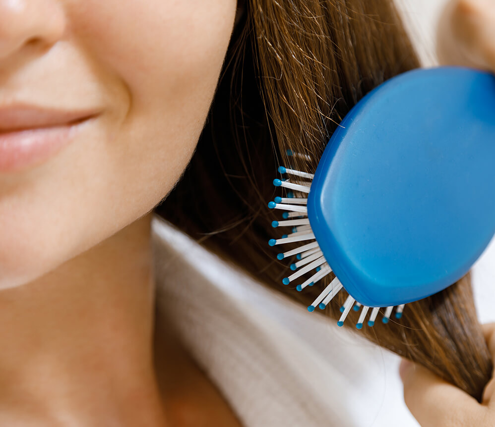 closeup of female hair with hair brush utc jpg